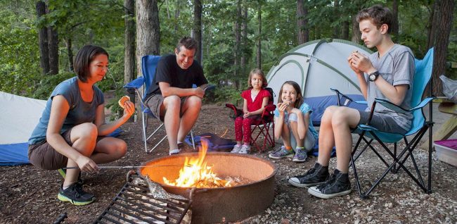 family enjoying summer camping