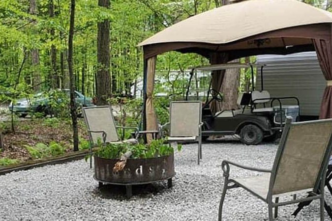 Seasonal RV campsite with patio, gazebo, and fire ring at American Wilderness Campground in Grafton, Ohio