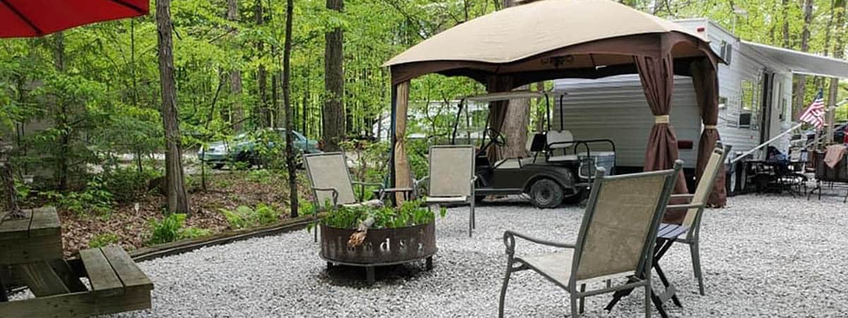 Seasonal RV campsite with patio, gazebo, and fire ring at American Wilderness Campground in Grafton, Ohio
